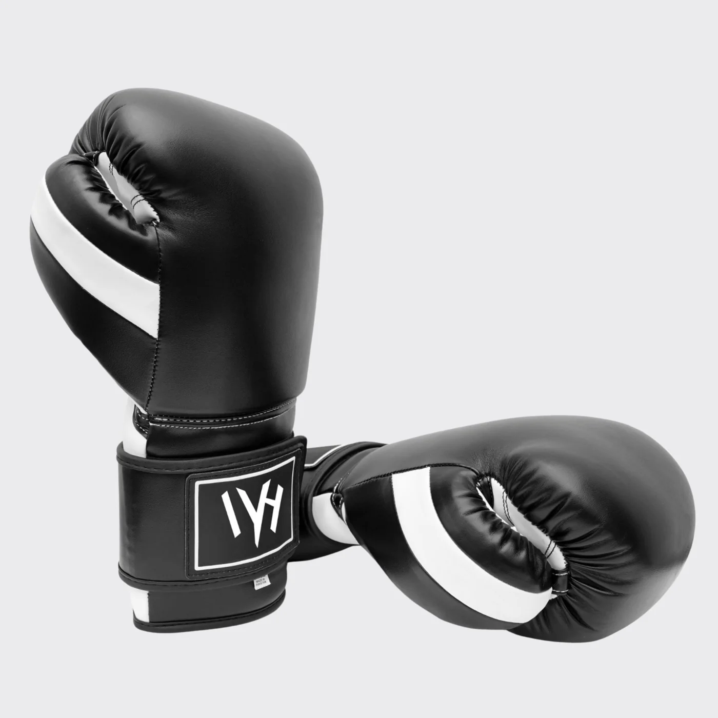 mayhm premium boxing gloves MAYHM Premium Boxing Gloves in black and white side view featuring ergonomic design, multi-layer padding, and reinforced wrist support for boxing training and sparring.
