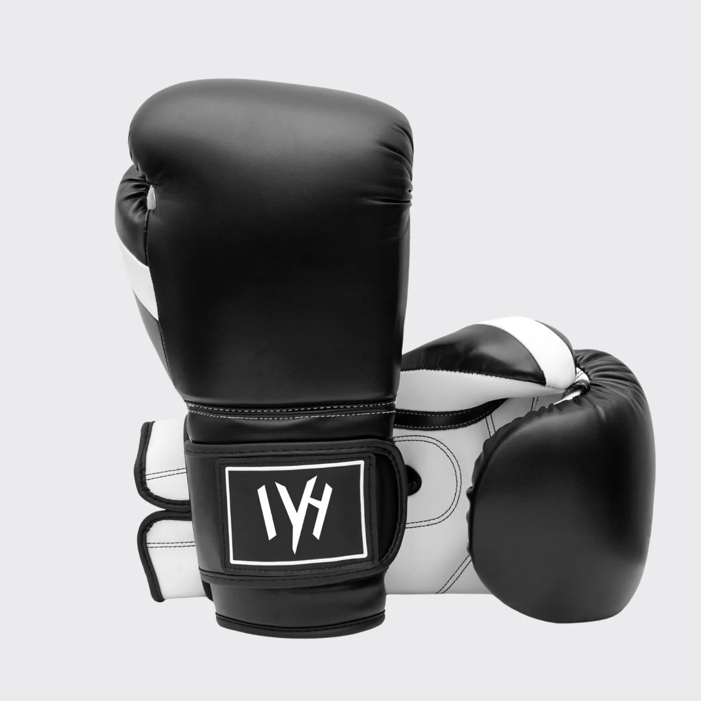 mayhm premium boxing gloves MAYHM black and white training boxing gloves with hook-and-loop wrist closure for boxing, fitness training, bag work, and sparring.